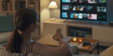 Woman watching TV at home and relaxing